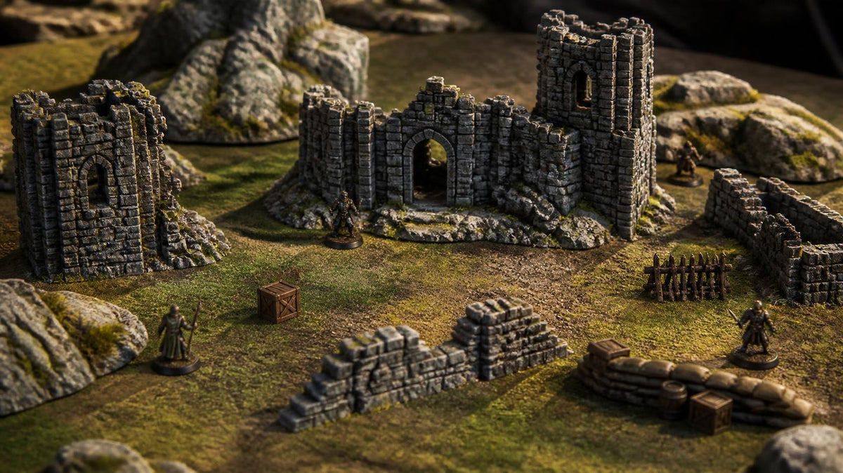 Painted tabletop terrain of ruined stone towers, walls, rocks and crates on a grassy gaming mat with miniatures